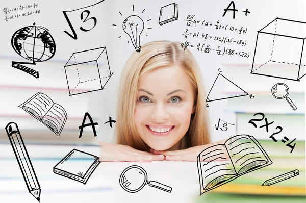 Estudiante con pila de libros y garabatos — Foto de Stock