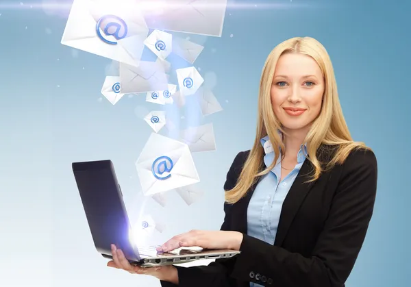 Businesswoman holding laptop with email sign — Stock Photo, Image