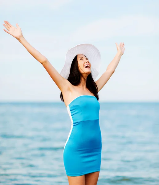 Girl with hands up on the beach — Stock Photo, Image