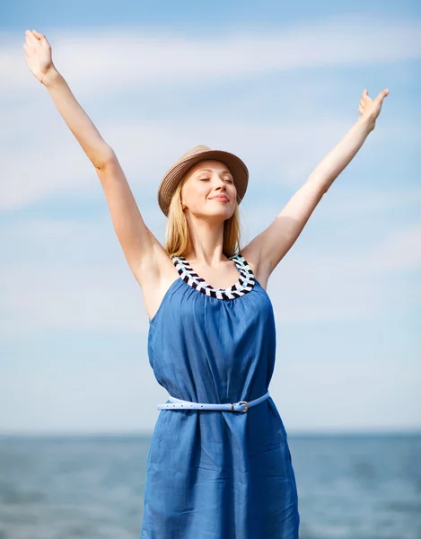 Girl with hands up on the beach — Stock Photo, Image