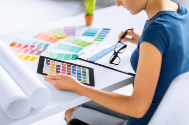 Woman working with color samples for selection clipart
