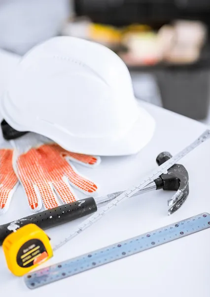 Blueprint, flexible ruller, helmet and hammer — Stock Photo, Image