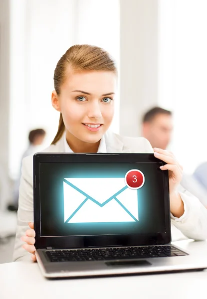 Businesswoman holding laptop with email sign — Stock Photo, Image