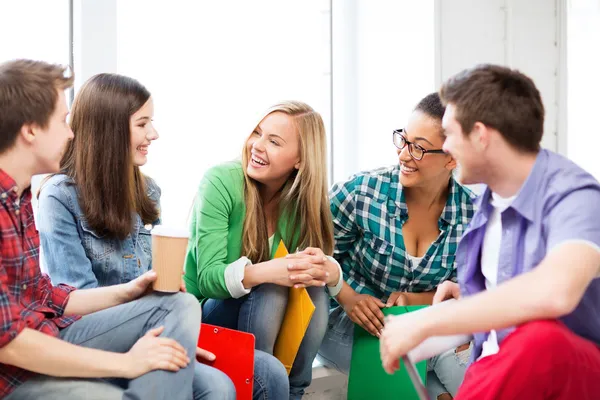 Students communicating and laughing at school — Stock Photo, Image