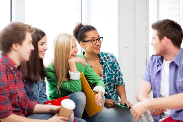 Students communicating and laughing at school — Stock Photo, Image