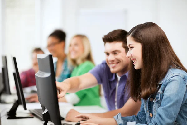 Students with computers studying at school — Stock Photo, Image