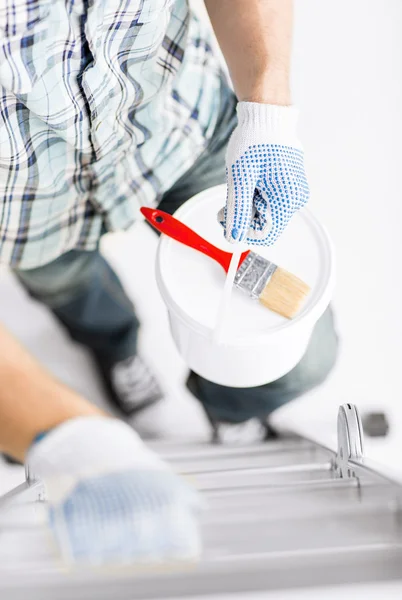 Man with paintbrush, pot and ladder — Stock Photo, Image