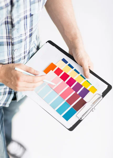 Man with color samples for selection — Stock Photo, Image