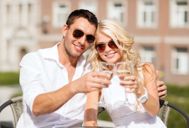 Couple drinking wine in cafe clipart