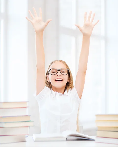 Girl with books and hands up — Stock Photo, Image