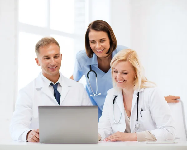 Group of doctors looking at tablet pc — Stock Photo, Image