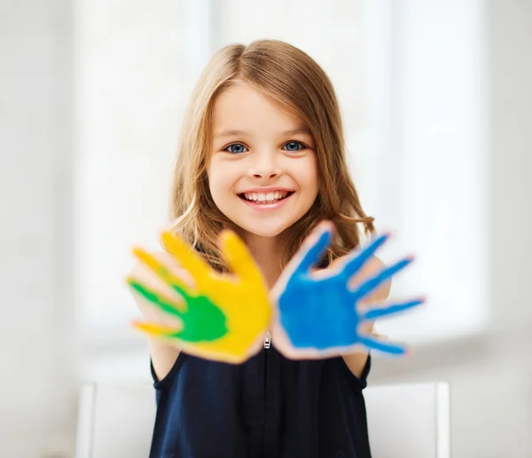 Girl showing painted hands — Stock Photo, Image