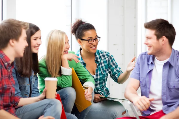 Students communicating and laughing at school — Stock Photo, Image