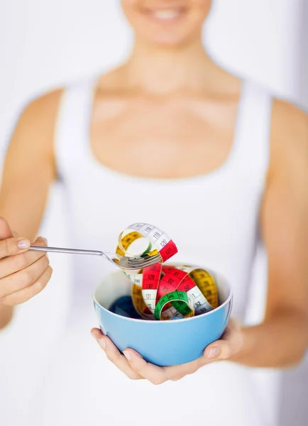 Woman hands holding bowl with measuring tape — Stock Photo, Image