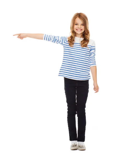 Cute little girl pointing to the side — Stock Photo, Image