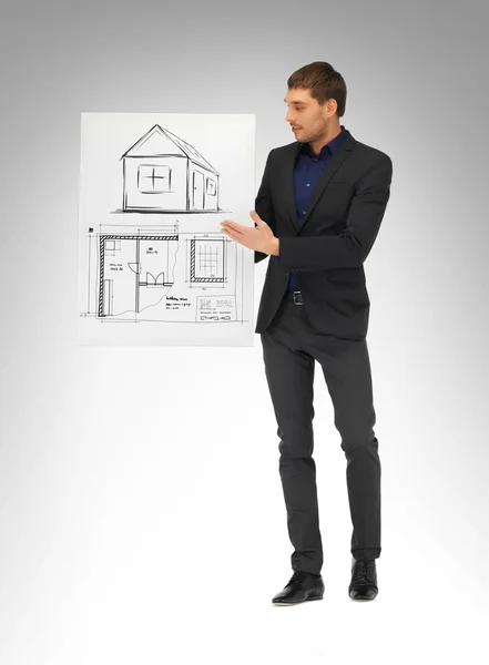 Man holding picture with house — Stock Photo, Image