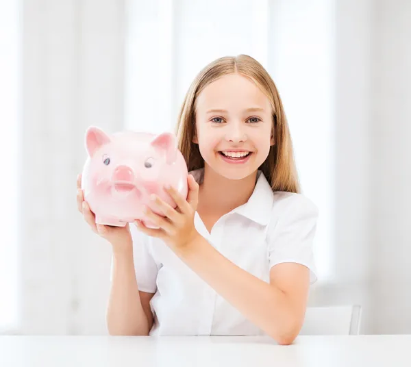 Criança com banco porquinho — Fotografia de Stock