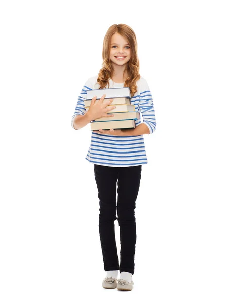 Kleines Studentenmädchen mit vielen Büchern — Stockfoto