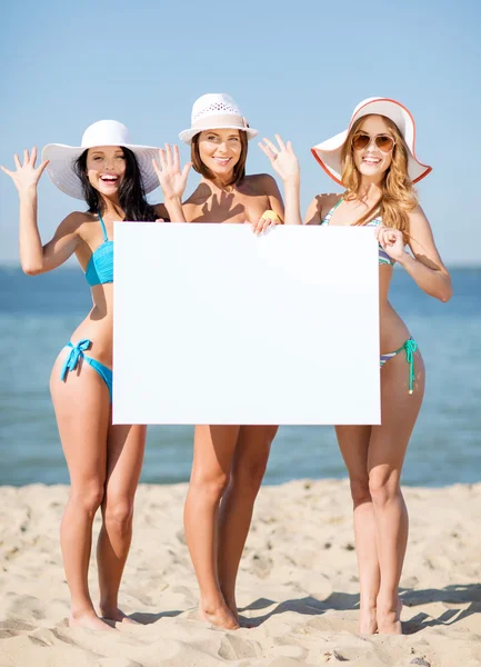 Girls with blank board on the beach — Stock Photo, Image