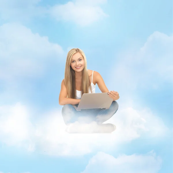 Woman sitting on the cloud with laptop — Stock Photo, Image