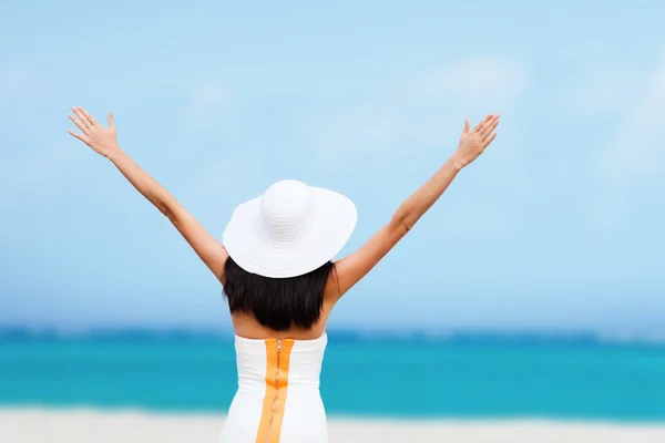 Girl with hands up on the beach — Stock Photo, Image