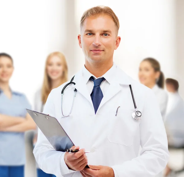 Male doctor with stethoscope and clipboard — Stock Photo, Image