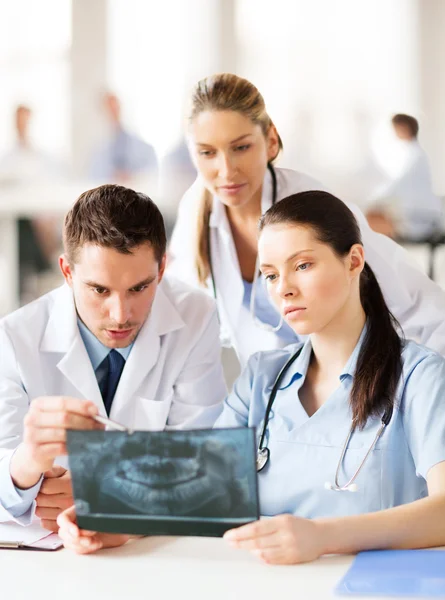 Group of doctors looking at x-ray — Stock Photo, Image