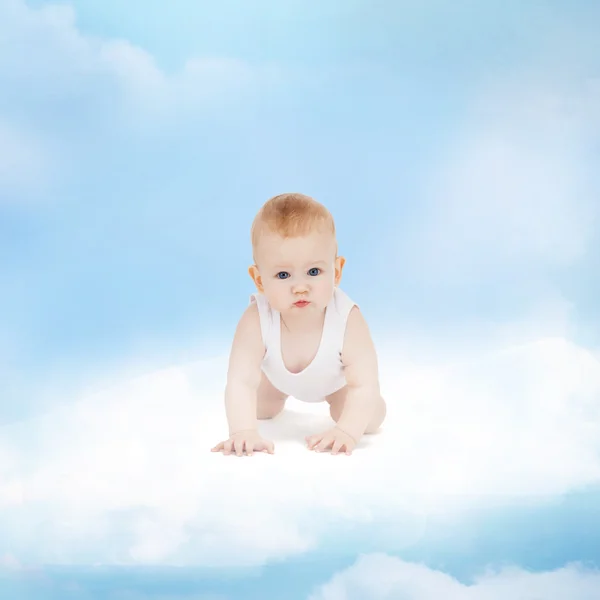 Smiling baby sitting on the cloud — Stock Photo, Image