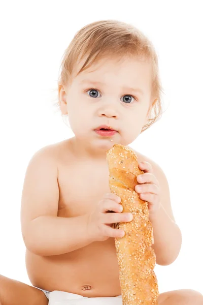 Søt smårolling som spiser langbrød – stockfoto