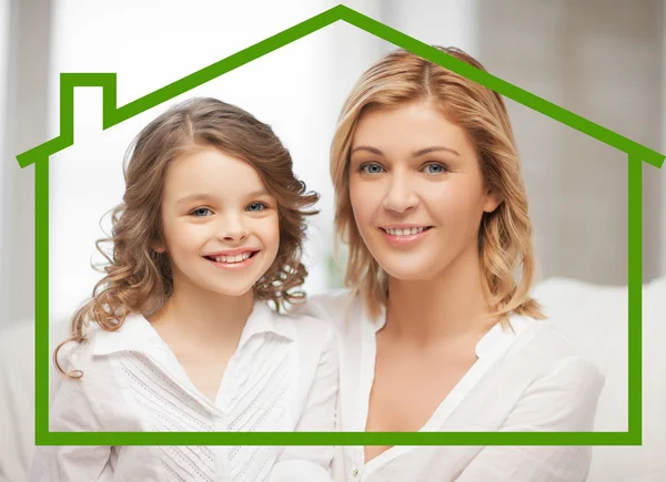 Mother and daughter with eco house — Stock Photo, Image