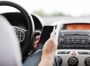 Man using phone while driving the car clipart