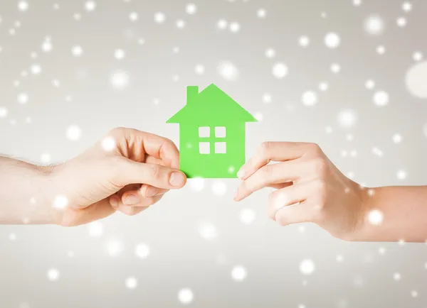 Couple hands holding green house — Stock Photo, Image