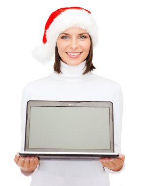 Woman in santa helper hat with laptop computer clipart