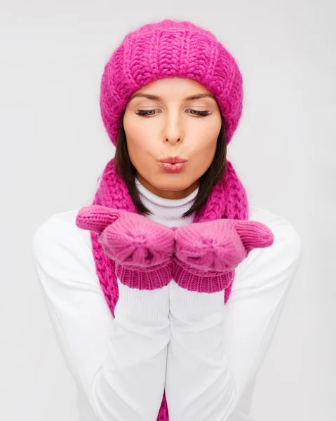 Happy woman in winter clothes blowing on palms — Stock Photo, Image