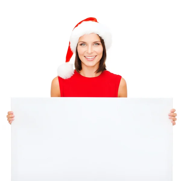 Vrouw in helper kerstmuts met een leeg wit bord — Stockfoto