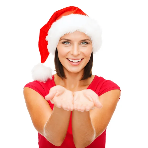 Woman in santa helper hat with something on palms — Stock Photo, Image