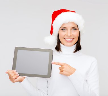 Woman in santa helper hat with tablet pc clipart