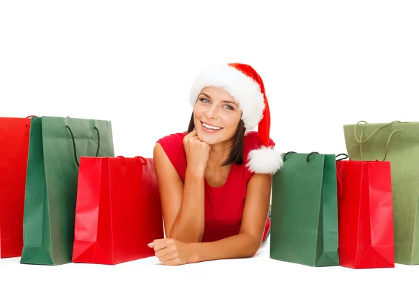 Woman in red shirt with shopping bags — Stock Photo, Image