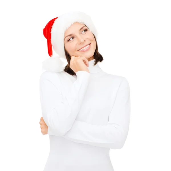 Myšlení a usmívající se žena v santa hat pomocníka — Stock fotografie