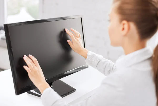 Smiling businesswoman with touchscreen in office — Stock Photo, Image