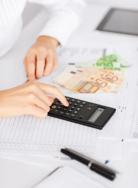 Woman hand with calculator and euro money — Stock Photo, Image