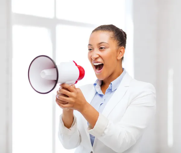 Strict businesswoman shouting in megaphone — Stock Photo, Image