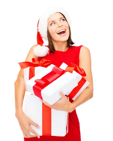 Woman in santa helper hat with many gift boxes Stock Image