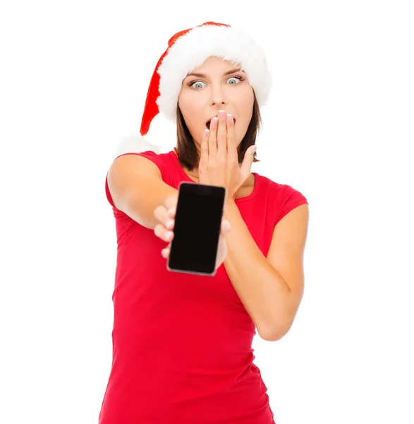 Vrouw in helper kerstmuts met smartphone — Stockfoto