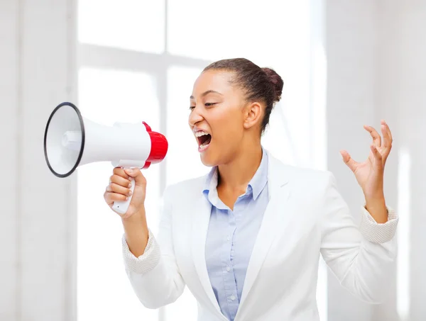 Strict businesswoman shouting in megaphone — Stock Photo, Image