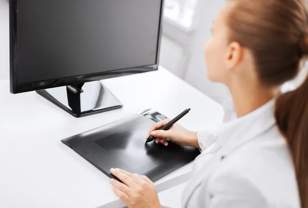 Businesswoman with drawing tablet in office — Stock Photo, Image