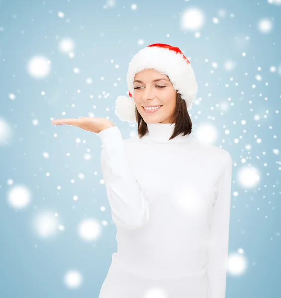 Woman in santa helper hat with something on palm — Stock Photo, Image