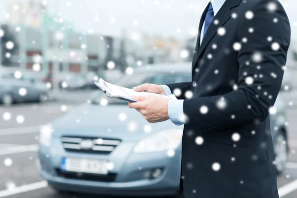 Man with car documents outside — Stock Photo, Image