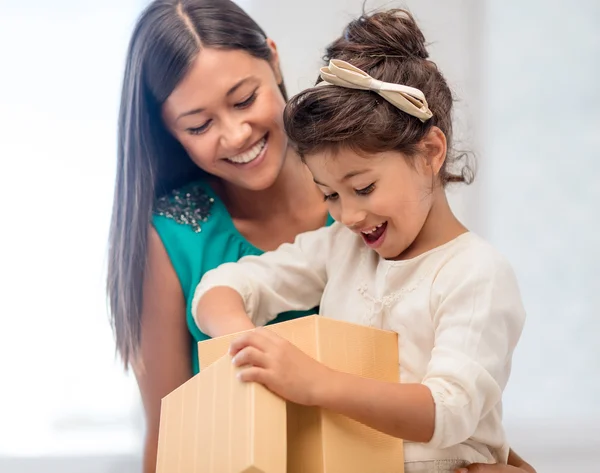 Happy mother and child girl with gift box Stock Photo