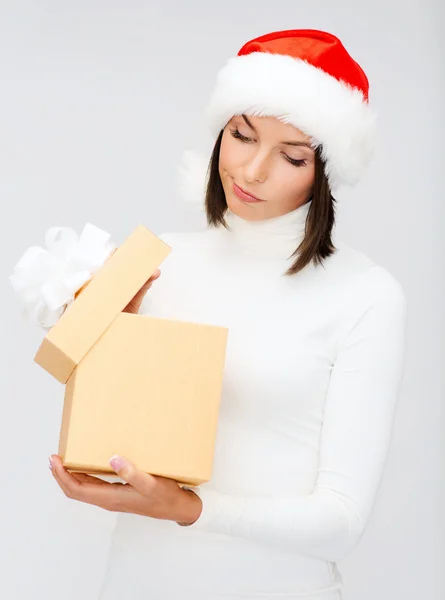 Sospetta donna in cappello Babbo Natale helper con confezione regalo — Foto Stock